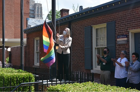 Chief of Human Resources Chris Tierney raises Pride flag in hospital courtyard